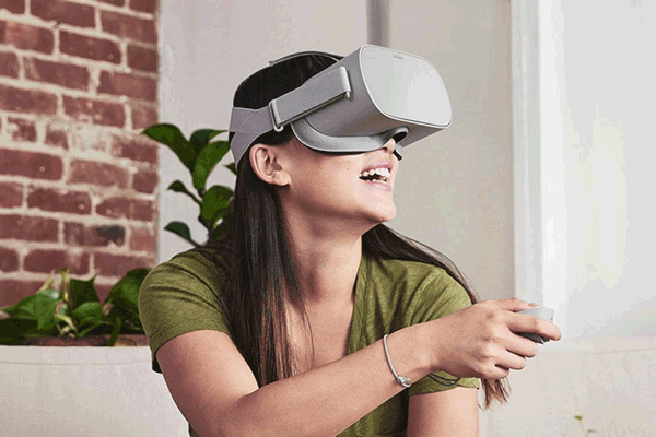 A woman wearing VR glasses dives into virtual worlds.